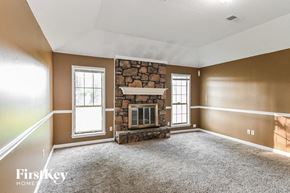 Memphis house for rent - an empty living room with a stone fireplace