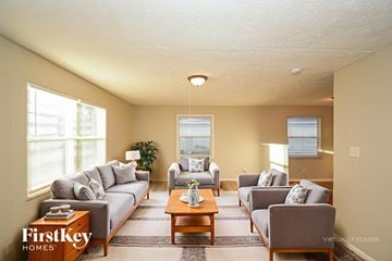 Indianapolis house for rent - A living room with a grey couch and a coffee table.