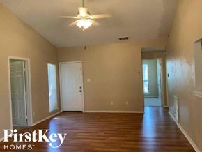 Rowlett house for rent - A room with wooden floors and a ceiling fan.