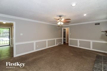 Memphis house for rent - a living room with a ceiling fan and a carpet