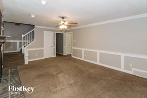 Memphis house for rent - a living room with a carpeted floor and a ceiling fan