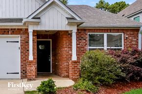 Bessemer house for rent - A brick house with a white garage door and a black door.