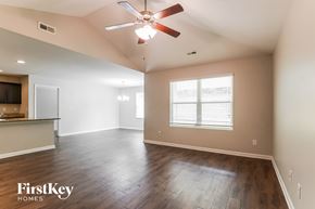 Bessemer house for rent - A spacious room with a ceiling fan and wooden flooring.