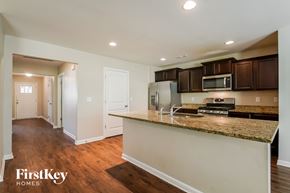 Bessemer house for rent - A kitchen with granite countertops and wooden cabinets.