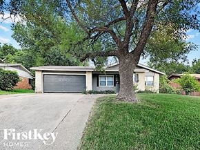 Dallas house for rent - a house with a tree in front of it