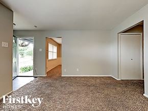 Dallas house for rent - an empty living room with a door to a hallway