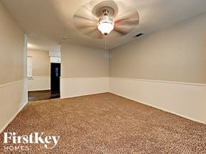 Dallas house for rent - an empty living room with a white ceiling fan