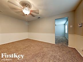 Dallas house for rent - the living room of an empty house with a ceiling fan