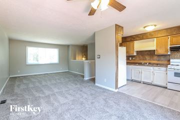 Indianapolis house for rent - A spacious living room with a kitchen area in the background.