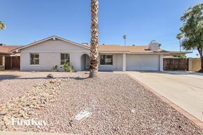 Glendale house for rent - a white house with a palm tree in front of it