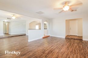 Glendale house for rent - the living room and dining room with wood flooring and a ceiling fan
