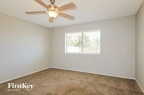 Glendale house for rent - a bedroom with a ceiling fan and a window