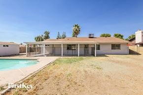 Glendale house for rent - a white house with a pool and a fence