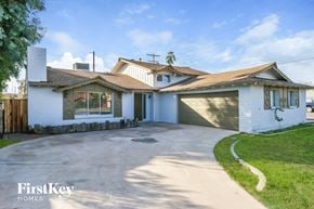 Glendale house for rent - a white brick house with a driveway and a garage door
