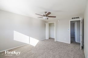 Glendale house for rent - a bedroom with white carpet and a ceiling fan