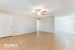 Phoenix house for rent - A room with a ceiling fan and tile flooring.