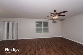 Pinson house for rent - the living room of an empty house with a ceiling fan