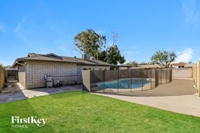 Glendale house for rent - a backyard with a pool and a fence and a house