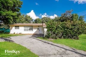 Plantation house for rent - a small white house with a dirt road in front of it