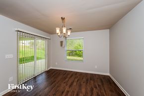 Pinson house for rent - the living room of a house with wood flooring and a large window