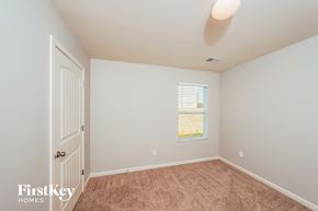 Pinson house for rent - a bedroom with carpet and a door to a closet