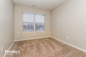 Greenwood house for rent - a spacious room with carpet and a window