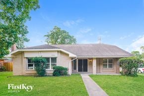 Houston house for rent - A house with a lawn in front of it.