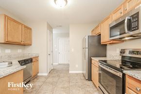 Greensboro house for rent - a kitchen with stainless steel appliances and wooden cabinets