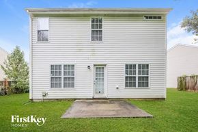 Greensboro house for rent - the outside of a white house with a driveway and grass