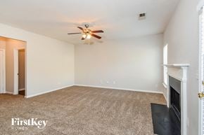 Cumming house for rent - A room with a carpeted floor and a ceiling fan.