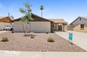 Tempe house for rent - a white brick house with a gravel driveway and a palm tree