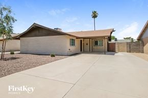 Tempe house for rent - a white house with a driveway and a palm tree
