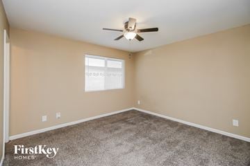 Tempe house for rent - the spacious living room with carpet and a ceiling fan
