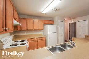 Lehigh Acres house for rent - A kitchen with wooden cabinets and a stove top oven.