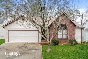 Sugar Hill house for rent - a brick home with a white garage door and a tree in the yard