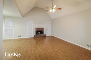 Sugar Hill house for rent - a living room with a fireplace and a ceiling fan