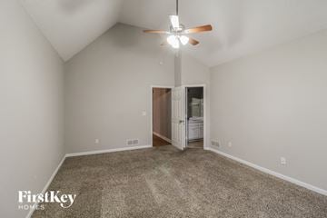 Sugar Hill house for rent - a spacious living room with carpet and a ceiling fan