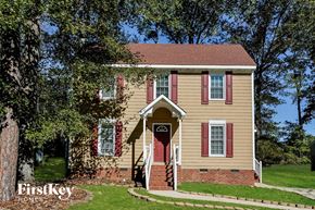 Knightdale house for rent - A house with a red door and red shutters is for sale.