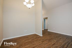 Winter Haven house for rent - a living room and dining room with wood flooring and a chandelier