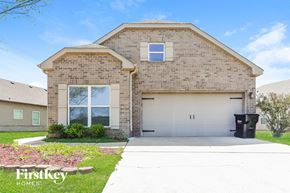 Mccalla house for rent - a brick house with a garage and a white driveway