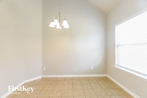 Mccalla house for rent - a dining room with a large window and a tiled floor