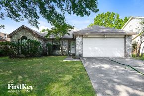 Arlington house for rent - a white brick house with a white garage door