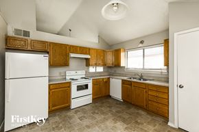 Arlington house for rent - a kitchen with white appliances and wooden cabinets