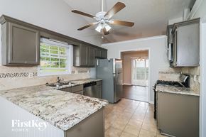 Alpharetta house for rent - a kitchen with stainless steel appliances and marble counter tops