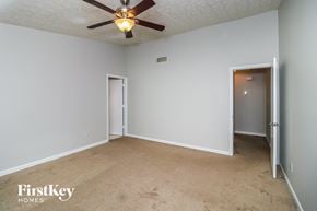Alpharetta house for rent - a bedroom with white walls and a ceiling fan