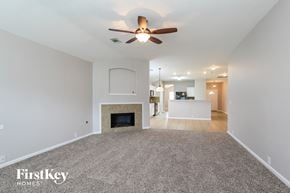 Kingwood house for rent - a living room with a fireplace and a ceiling fan