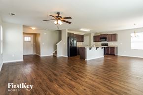 Bessemer house for rent - an empty living room and kitchen with wood flooring and a ceiling fan