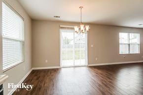 Bessemer house for rent - an empty living room with wood floors and a sliding glass door