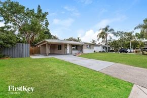 Oakland Park house for rent - a white house with a driveway and a lawn