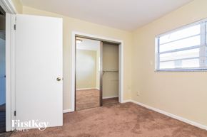 Tampa house for rent - a bedroom with a closet and a window and a door to a closet